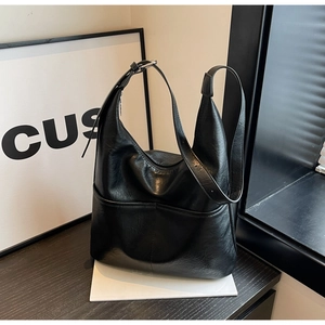 Detail view of the black textured PU leather bucket bag with silver metal buckle