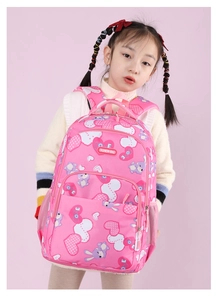 Pink ergonomic school bag featuring cute rabbit and heart prints on a young girl model