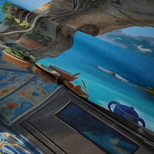 Close-up of bohemian wall tapestry showing detailed seaside landscape print and fabric texture