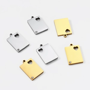 Macro detail of rectangle stainless steel pendant with hollow heart and inset crystal