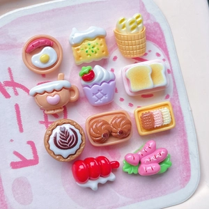 Flat lay macro of miniature resin breakfast food charms for DIY hair accessories and crafts