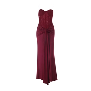 Detailed view of burgundy lace patchwork and pleated waist on evening gown dress