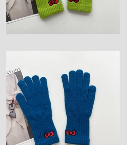 Close-up of knitted gloves featuring red bow embroidery and elastic ribbed cuffs