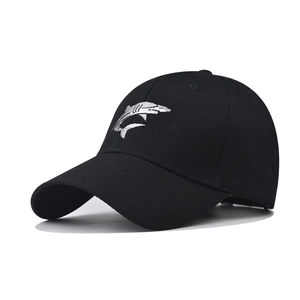 Detail of shark embroidery and canvas texture on a black washed cotton baseball cap