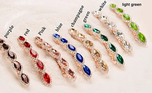 Detailed view of eight vintage rhinestone spring hair clips in various vibrant colors