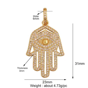 Detailed view of a gold-plated Hamsa Hand pendant with white zircon pavé and 31x23mm dimensions