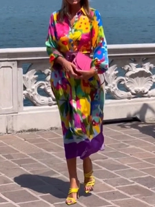 Elegant floral print shirt dress with long sleeves and pink belt for women in lake setting