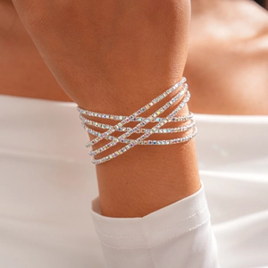 Detail of three-layer silver-toned bracelet with iridescent rhinestones on wrist