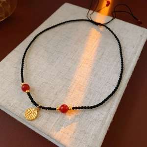 New Chinese style red bean necklace with golden Fu pendant on black woven rope cord