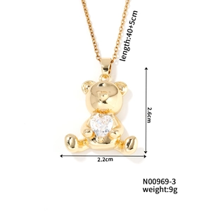 Detail view of gold teddy bear pendant with heart zircon and size specifications