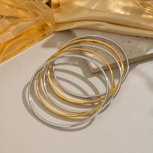 5-piece stackable stainless steel bangles set in gold and silver with textured finishes