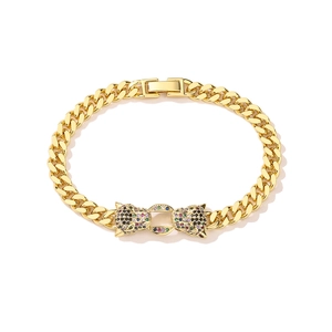 Detailed view of dual leopard head gold plated Cuban chain bracelet with colorful zircons