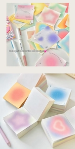 Close-up of square gradient sticky notes with high page count and inspirational text
