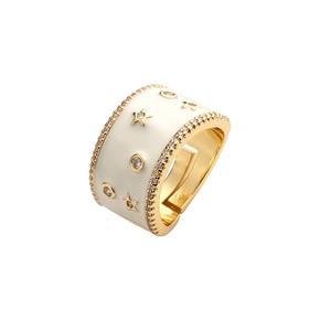 Adjustable gold star ring with white enamel and cubic zirconia on white background