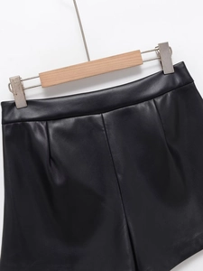 Detalle de la cintura de cuero PU negro mate y textura fina de la minifalda de moda