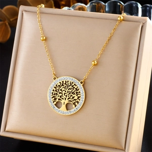 Golden tree of life necklace set with sparkling crystals in an elegant jewelry box