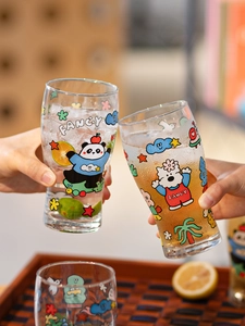 Close-up of glass beer mugs with cute cartoon panda prints in a toasting scene