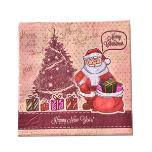 Detail of Christmas paper napkins with Santa Claus, Xmas trees and gift boxes print