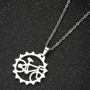 Silver vintage sunflower necklace with horseshoe heart pendant on black background