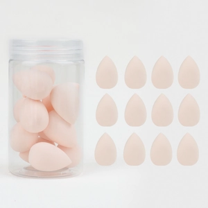 Macro detail of twelve pink teardrop beauty blenders with a clear storage canister