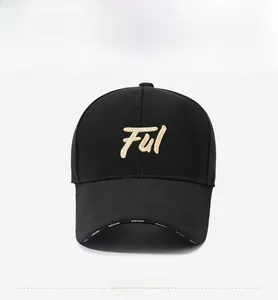 Detailed front view of black baseball cap featuring high-density gold letter embroidery
