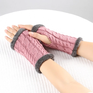 Detail of pink cable knit arm warmers with grey faux fur trim on a white background