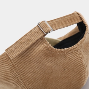 Detail of khaki corduroy hat showing silver metal adjustable buckle and stitching