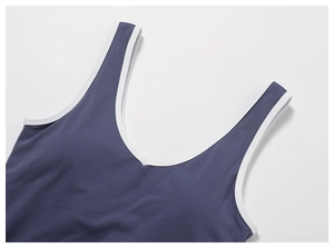 Detail of grey-blue sports vest with white contrast piping and V-neckline texture