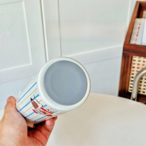 Detail shot of the non-slip bottom and cartoon reindeer pattern on this insulated cup