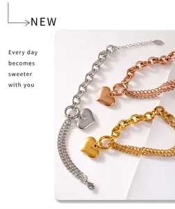 Macro shot of three-tone heart pendant bracelets with bold gold and silver chain textures