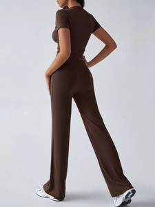 Back view of a woman wearing a dark brown short sleeve top and wide-leg trousers set