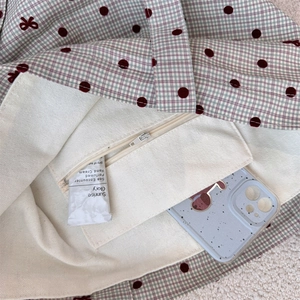 Detail view of canvas tote interior featuring a zippered pocket for small essentials