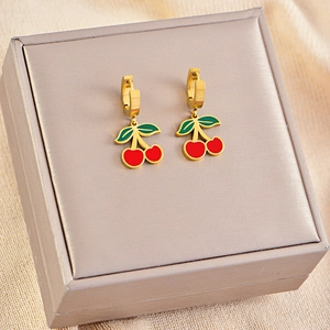 Close-up of sweet red cherry earrings with gold hooks on a premium jewelry box