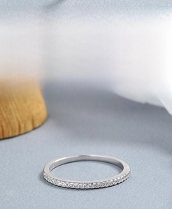 Macro shot of 925 sterling silver eternity ring with zircon stones on a wooden stand