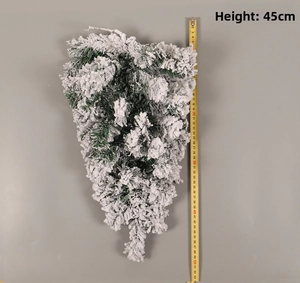 Close-up of a 45cm snow-flocked artificial Christmas pine swag with thick white frosting