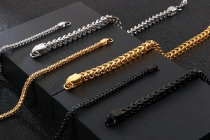 Detail of Franco wheat chain bracelets in gold, silver, and black stainless steel finish