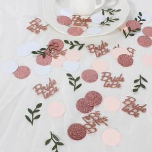 Detailed view of rose gold glitter Bride to be confetti and circles for party decor
