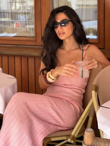 Detail of pink knitted ribbed dress with spaghetti straps and a v-neckline