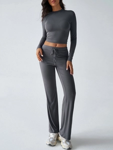 Detail of grey Y2K ribbed long sleeve crop top and drawstring pants set on a studio model