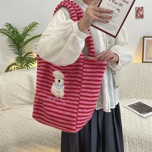 Detail of soft striped plush tote with cute white dog embroidery and Happy Dog text
