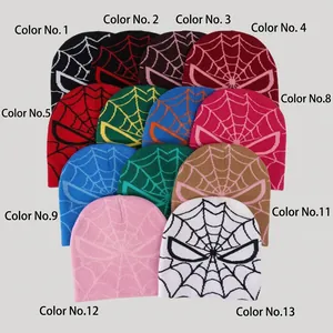 Flat lay of knit beanies with spider-man web jacquard patterns in thirteen colors
