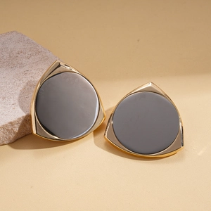 Macro shot of 14K gold plated triangle earrings with grey round inlay on stone