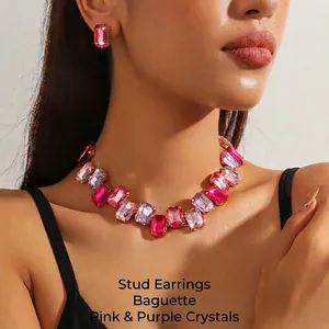 Detail of a luxury jewelry set featuring pink rectangle crystals on a gold chain necklace