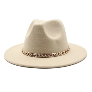 Detail of solid wool fedora hat featuring a chunky gold chain accessory in beige
