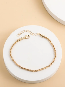 Detail of 18K gold-plated twisted rope chain bracelet with adjustable lobster clasp closure
