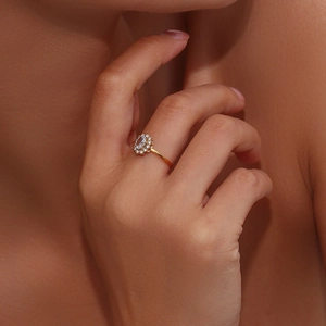 Detail of 18K gold plated adjustable ring with oval zircon and pavé crystals on a model