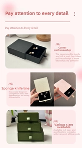 Detail of multi-color drawer jewelry boxes with ribbon handles and foam inserts