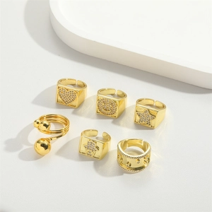 Collection of six vintage gold adjustable rings featuring heart, star, and smiley designs