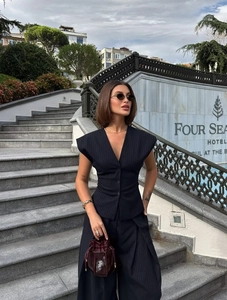 Detail of dark blue pinstripe v-neck vest and wide leg trousers for business commute