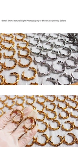 Detail showing C-shaped metal hoop earrings with beaded texture in gold and silver finish